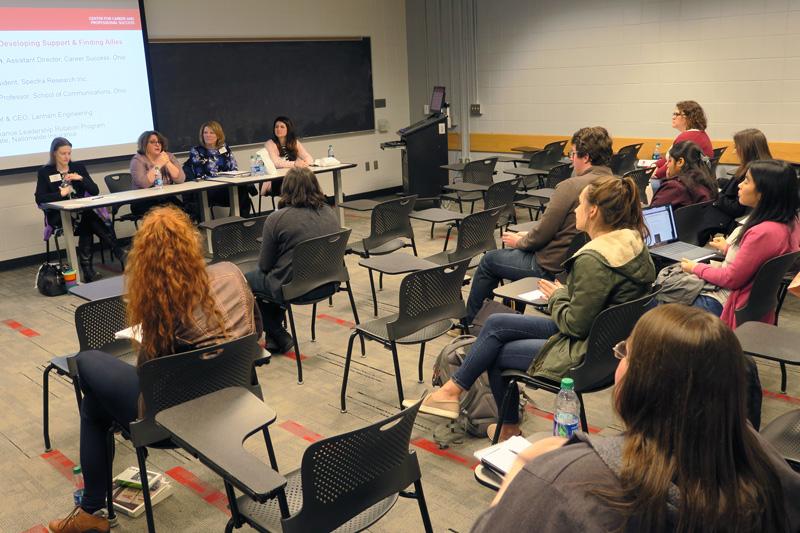 Students listen to a panel discussion during a Development Academy