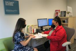 A Career Coach shares feedback on a student's job application materials in a Career Coaching office