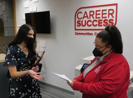 A student chats with a Career Coach in the lobby of ASC Career Success.