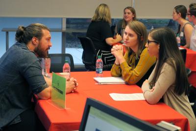 Two students talk with an alumni at a Life Beyond Degree event