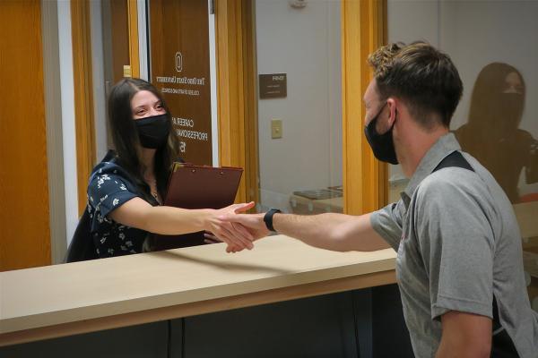 A student is greeted as she checks in to the Center for Career and Professional Success