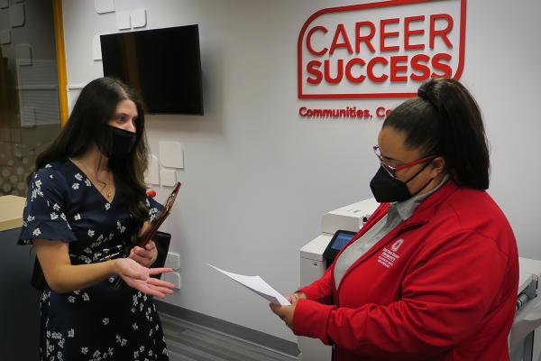 A student shares her resume with a Career Coach in the reception area of the Center for Career and Professional Success