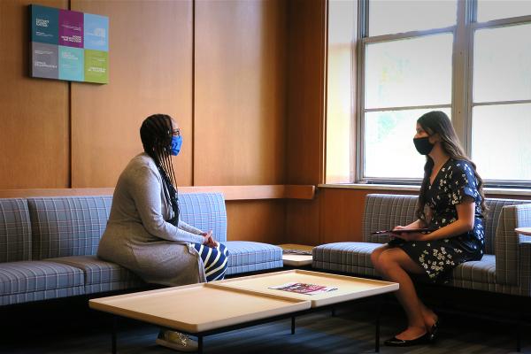 Career Coach Brandy sits with a student in the Employer & Alumni  Hiring Suite