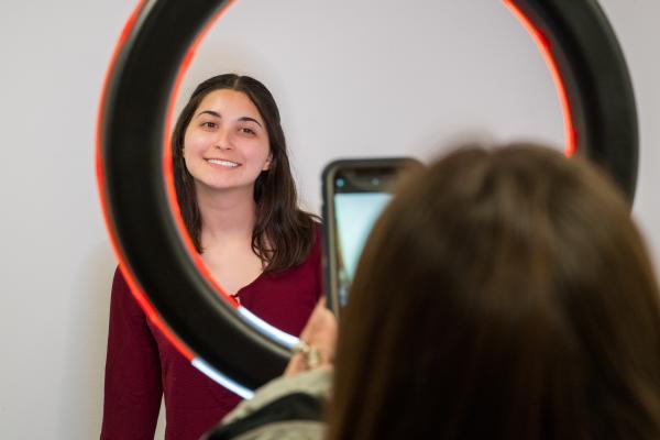 One of our Peer Career Coaches taking a Profile Photo with the students Phone