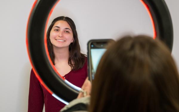 One of our Peer Career Coaches taking a Profile Photo with the students Phone