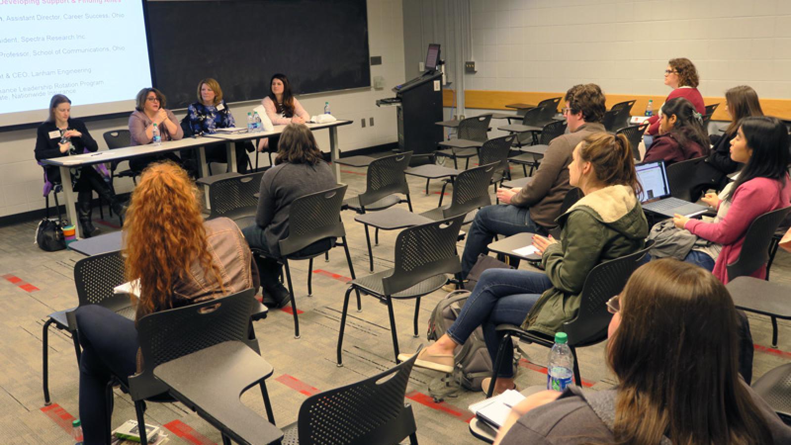 Students listen to a panel discussion during a Development Academy